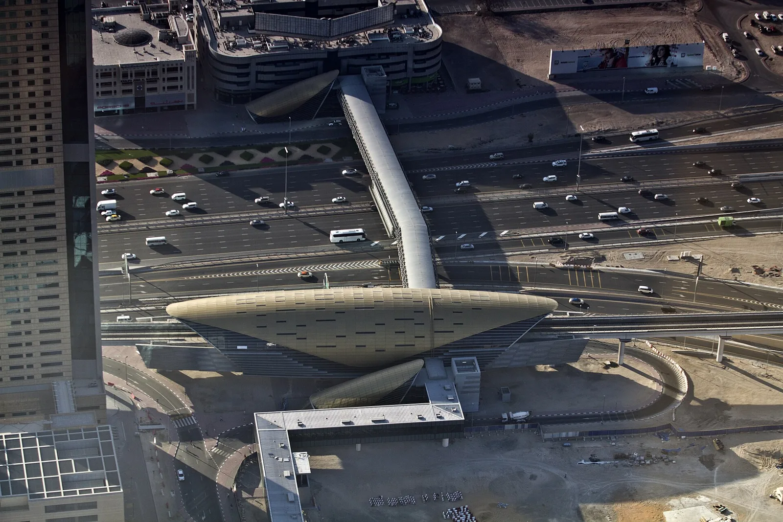 Burj Khalifa/Dubai Mall metro station seen from above, with the road and car parks around it