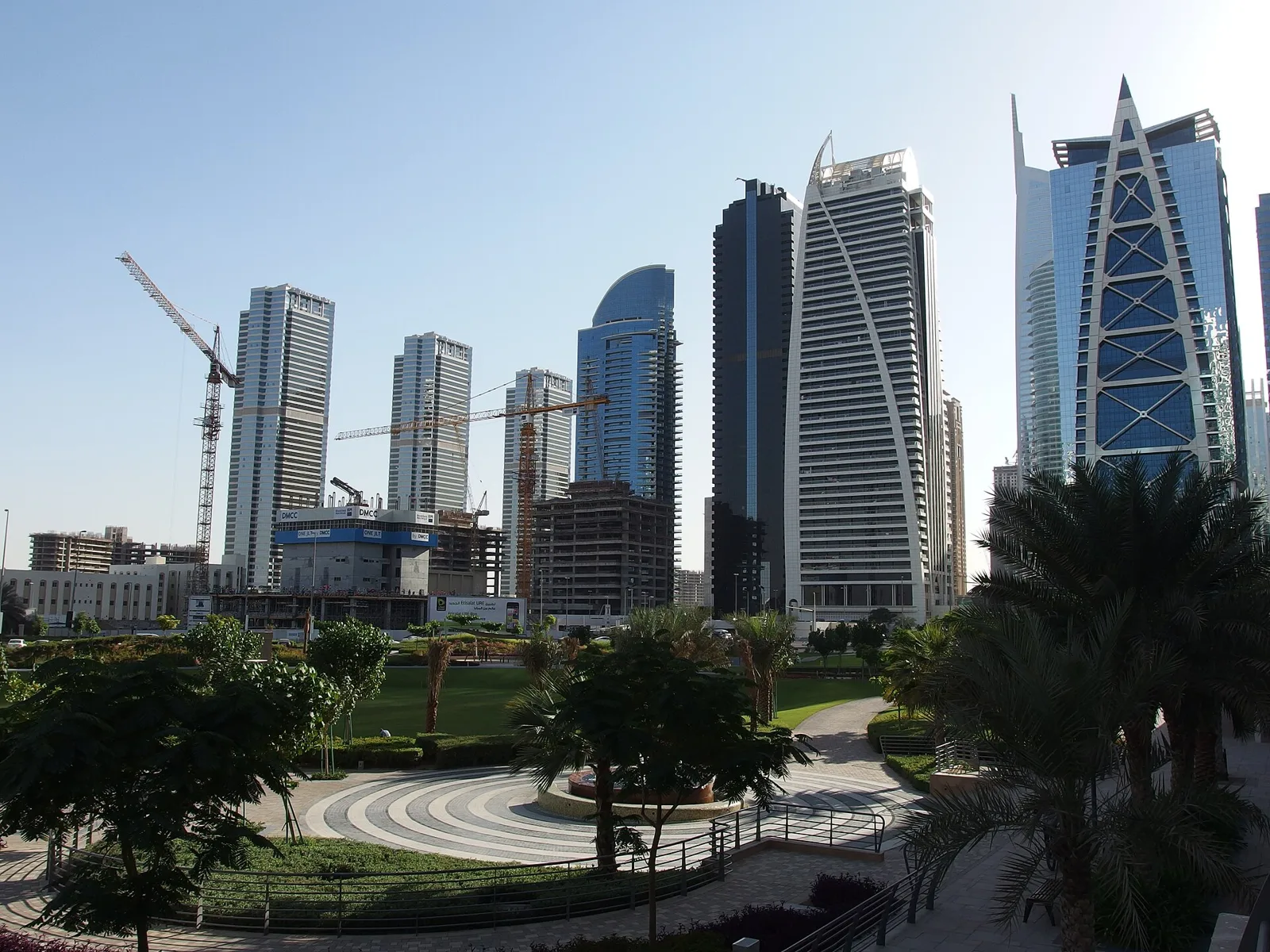 Jumeirah Lakes Towers park with palm trees and office towers behind