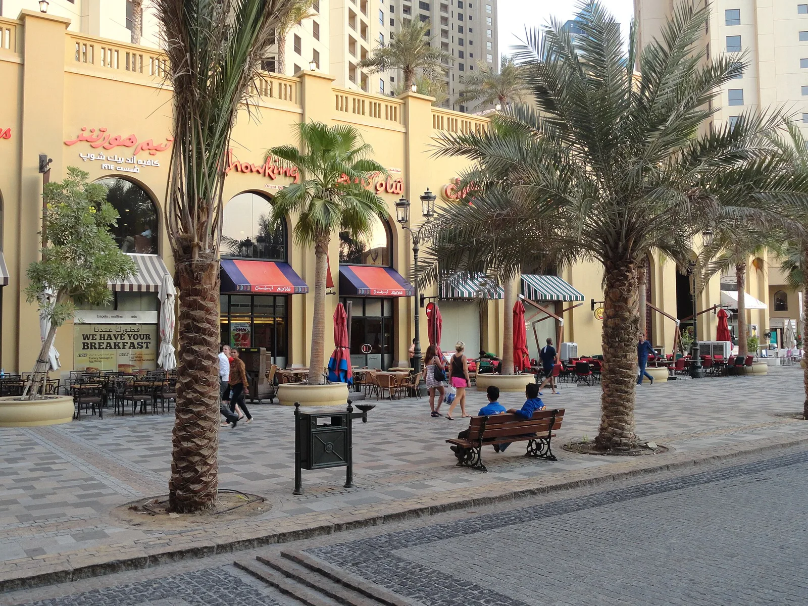 Palm-lined pedestrian promenade with shops and cafes at The Walk, JBR